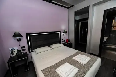 a bedroom with a large bed with two towels on it at Imperium Suite Navona in Rome