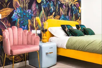 a bedroom with a yellow bed and a pink chair at Vatican City Deluxe - Suite con bagno privato - Vaticano a piedi in Rome