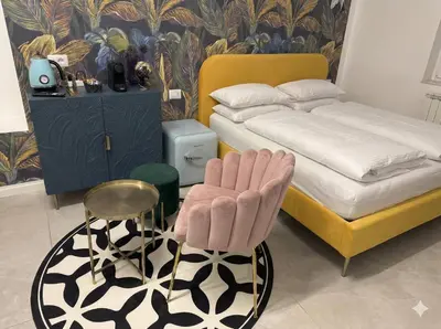 a bedroom with a bed and a chair next to a bed at Vatican City Deluxe - Suite con bagno privato - Vaticano a piedi in Rome