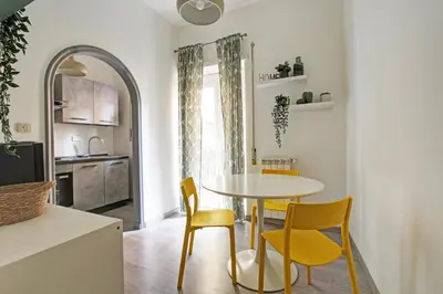 a kitchen and dining room with a table and chairs at Porta Portese Luxury Suites in Rome