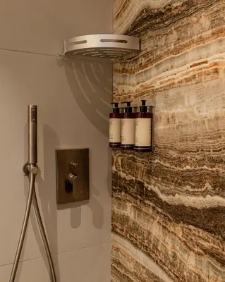 a wall with three bottles of wine on it at Flora Guest House in Rome