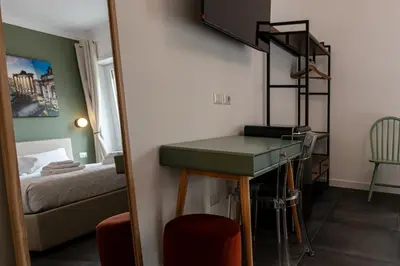 a bathroom with a sink and a bed in a room at Flora Guest House in Rome