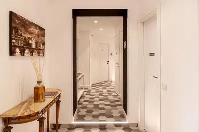 a hallway with a table and a hallway with at Flora Guest House in Rome
