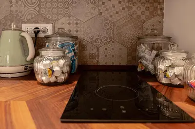 a kitchen counter with glass jars on a counter top at Flora Guest House in Rome