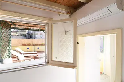 a room with a window and a table and chairs at Navona studio with terrace Backpackers in Rome