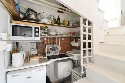 a small kitchen with a sink and a toilet at Navona studio with terrace Backpackers in Rome