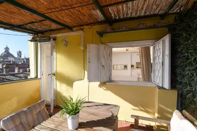 a balcony with a table and a window at Navona studio with terrace Backpackers in Rome