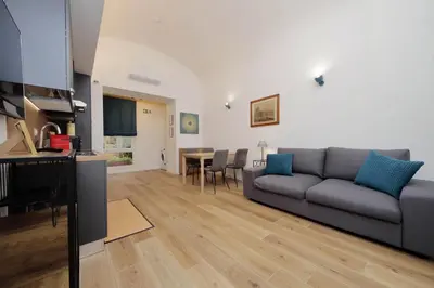 a living room with a couch and a table at Holy Mary Lovely Apartment in Rome