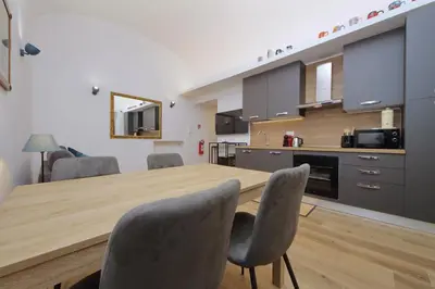 a kitchen with a large wooden table and chairs at Holy Mary Lovely Apartment in Rome