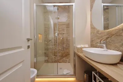 a bathroom with a sink and a shower at Holy Mary Lovely Apartment in Rome