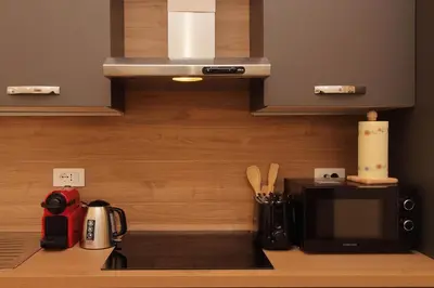 a kitchen with a counter with a microwave and a coffee maker at Holy Mary Lovely Apartment in Rome