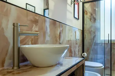 a bathroom with a white bowl sink on a counter at Furio Flat in Rome