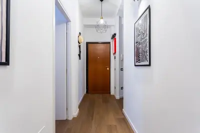 a hallway with white walls and a brown door at Furio Flat in Rome