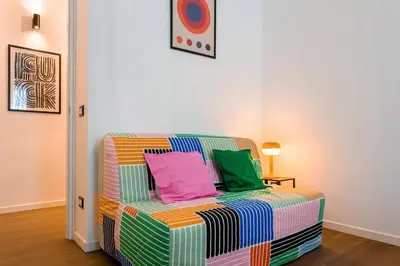 a colorful couch with colorful pillows sitting in a room at Furio Flat in Rome