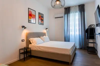 a bedroom with a bed and a ladder and a window at Furio Flat in Rome