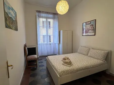 a small bedroom with a bed and a window at Appartamento a Roma vicino Metro Vittorio Emanuele in Rome