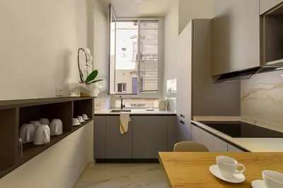 a kitchen with a table and a sink and a window at Aras Luxury Flat in Rome