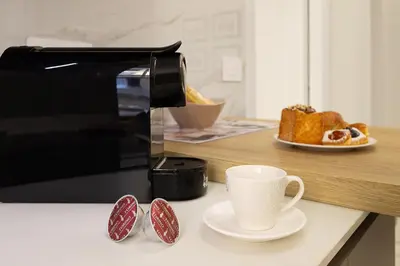 a toaster and a cup of coffee on a counter at Aras Luxury Flat in Rome