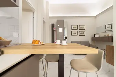 a kitchen with a wooden table and two chairs at Aras Luxury Flat in Rome