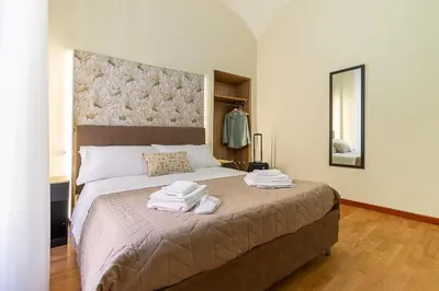 a bedroom with a large bed with towels on it at Aras Luxury Flat in Rome