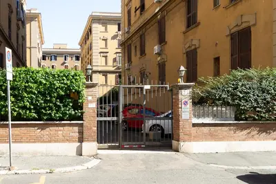 a gate to a building with a car behind it at Aras Luxury Flat in Rome
