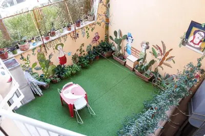a balcony with a garden with a table and plants at Menghini Easy Flat in Rome