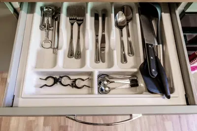 a drawer filled with kitchen utensils in a cabinet at Menghini Easy Flat in Rome