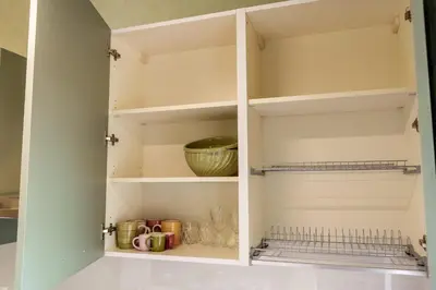 a kitchen pantry with white shelves and a bowl at Menghini Easy Flat in Rome