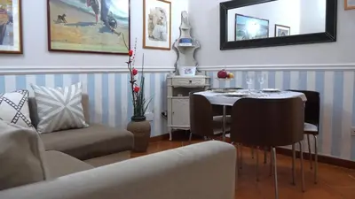 a living room with a table and a chair at Navona Apartment in Rome