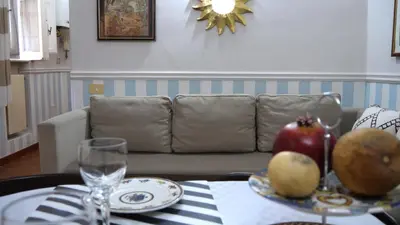 a living room with a couch and a table with fruit on it at Navona Apartment in Rome