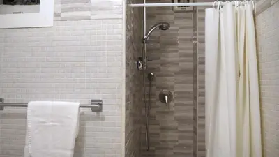 a bathroom with a shower with a shower curtain at Navona Apartment in Rome