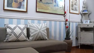a couch with pillows in a living room with pictures at Navona Apartment in Rome