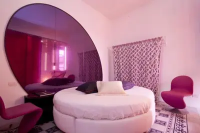 a bedroom with a white bed and a mirror at 3000rome Di Parione in Rome