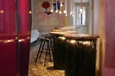 a bar with a row of stools in a room at 3000rome Di Parione in Rome