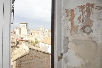 a view of a city from an open window at 3000rome Di Parione in Rome