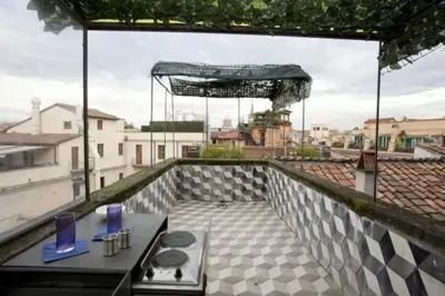 a balcony with a table and chairs on a roof at 3000rome Di Parione in Rome
