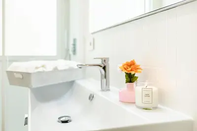 a bathroom sink with a candle and a mirror at La Saponeria - Roma Centro - Free Parking in Rome