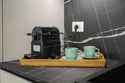 a coffee maker and two coffee cups on a counter at La Saponeria - Roma Centro - Free Parking in Rome