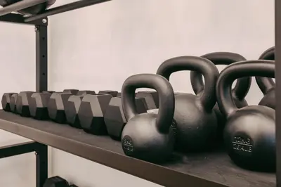 a row of black dumbbells sitting on a shelf at La Saponeria - Roma Centro - Free Parking in Rome