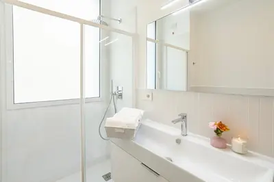 a white bathroom with a sink and a mirror at La Saponeria - Roma Centro - Free Parking in Rome