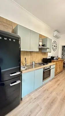 a kitchen with a black refrigerator and a sink at Saint Peter YH in Rome