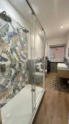 a bathroom with a shower with a glass wall at Saint Peter YH in Rome