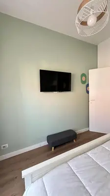 a room with a bed and a tv on the wall at Saint Peter YH in Rome