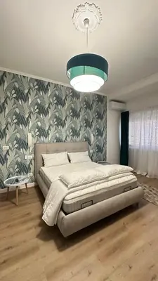 a bedroom with a large bed and a large chandelier at Saint Peter YH in Rome