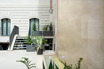a building with potted plants on the side of it at Fortyfive Squared Hotel in Rome