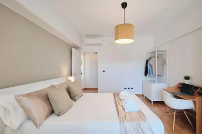 a white living room with a white couch and a desk at Trastevere-Colosseo, Elegant Apartment Wi-Fi & A-C in Rome