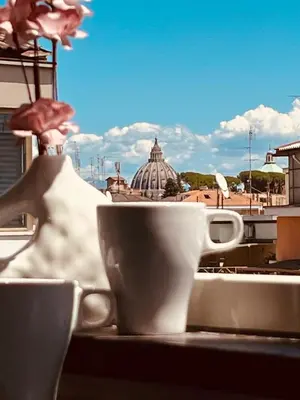 a cup on a table with a view of a city at Attico 22 in Rome
