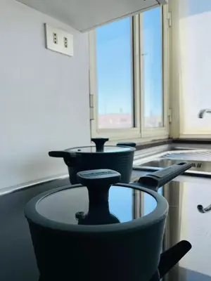 a kitchen with a glass table in the middle at Attico 22 in Rome