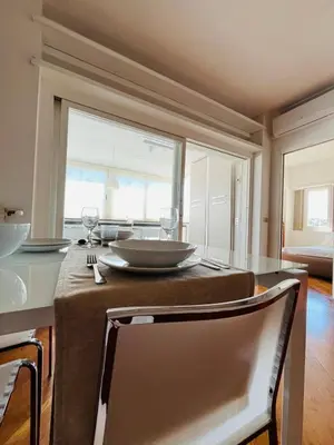 a kitchen with a table with a plate and wine glasses at Attico 22 in Rome
