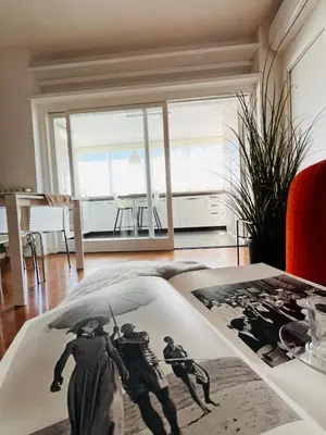 a living room with a picture of people with an umbrella at Attico 22 in Rome